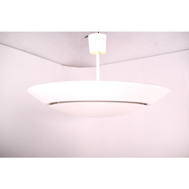 Two Scandinavian ceiling lamps in white lacquered aluminum. with indirect light. The light reflects up leaving the...