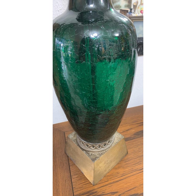 Striking vintage table lamp featuring a beautifully textured green crackle-glass body paired with a warm brass-tone base...