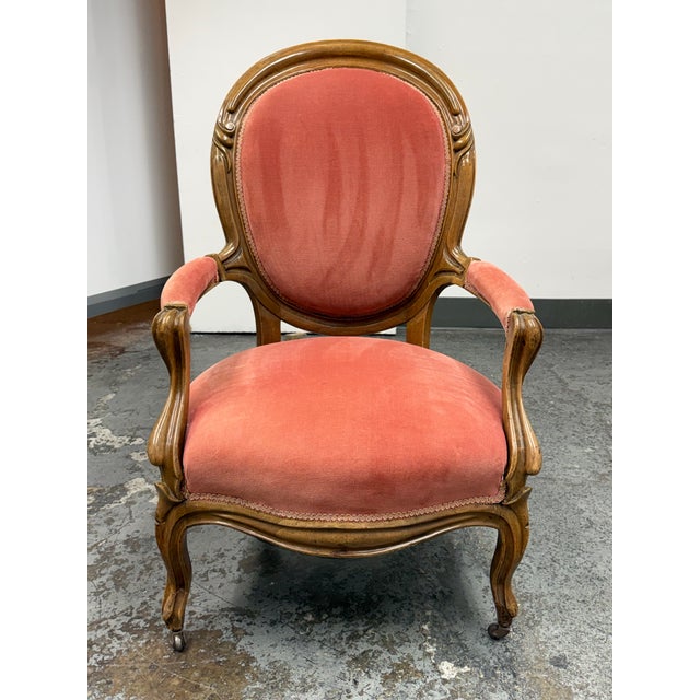 Design Plus Gallery presents a Victorian Rococo Revival Armchair. This antique armchair has a carved wood frame with a...