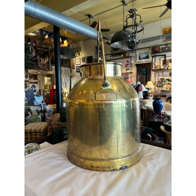 Unusual jug or milk jug in brass, beautifully polished with a handle attachment. Perfect as a floor vase. Patination only...