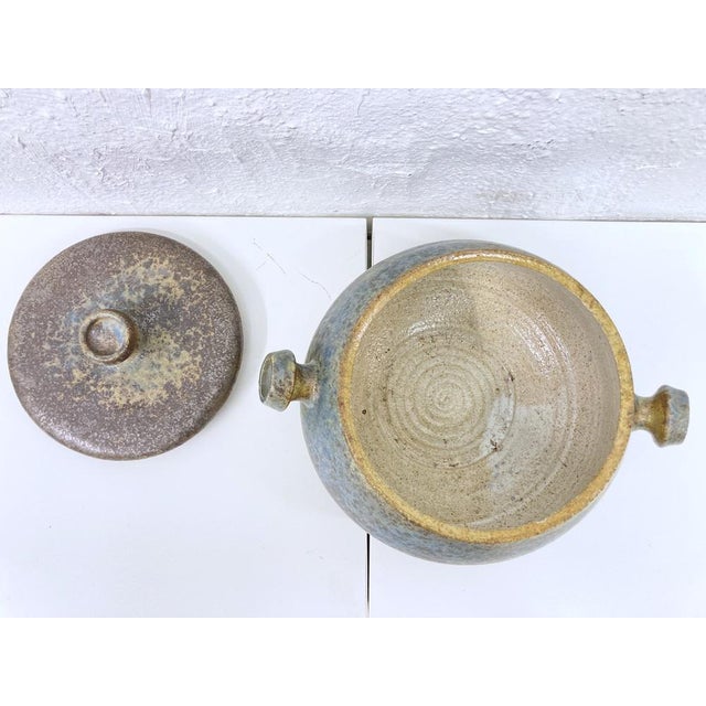 A bowl with a lid, made in 1979 by the German ceramicist Horst Seifert. The back is marked with the artist's name and the...