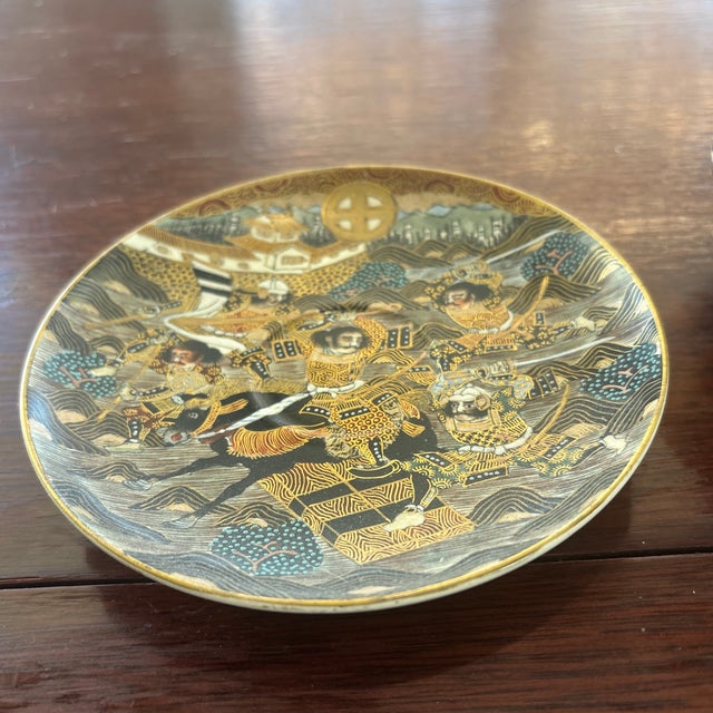 This is a really beautiful, intricate Satsuma cup and saucer that dates to the Meiji period and is painted with the...