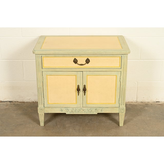 A gorgeous French Regency Louis XVI or French Provincial style nightstand By Baker Furniture USA, Circa 1960s Cream and...
