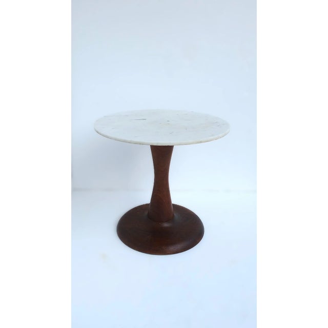 An Italian round marble and wood side drinks table, Italian Modern design period, circa mid-20th century, Italy. Tables...