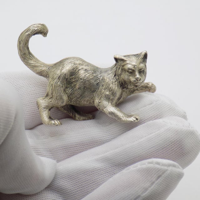 A lively vintage miniature depicting a playful cat, handmade in Milan, Lombardy, Italy between the 1960s and 1970s in...
