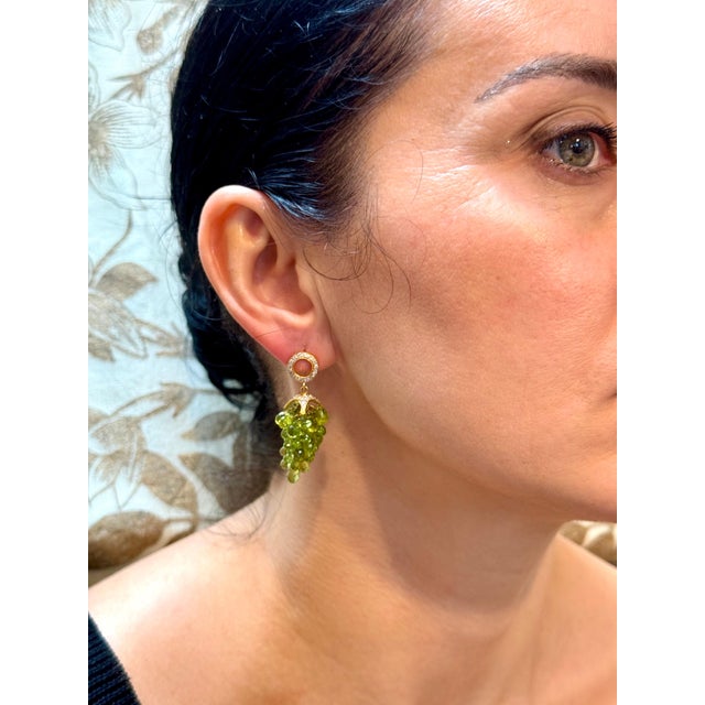 Approximately 40 Carats of natural Peridot Briolettes & Diamond Hanging Earrings 18 Karat Gold This exquisite pair of...