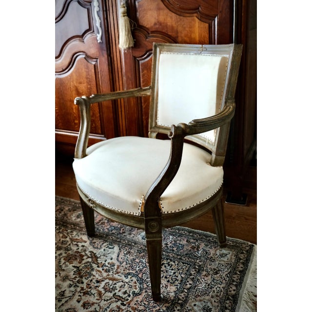 Extraordinary Italian Neoclassical fauteuil with parcel gilt and sage/grey/blue polychrome finish. Dramatic curved and...