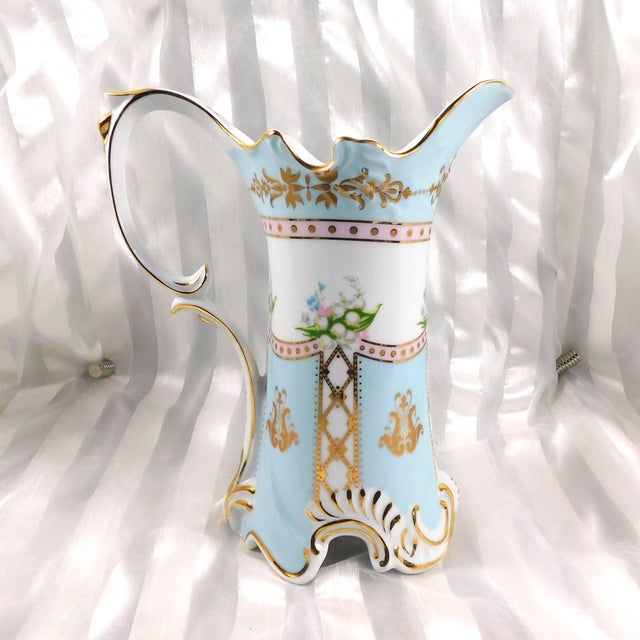 This is a light blue and white with some pink pitcher by Royal Danube. I can not find a pattern name or date for this...