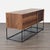 Italian console made of engineered wood, powder coated steel, and unfinished wood in a walnut finish. It has a flip-down...