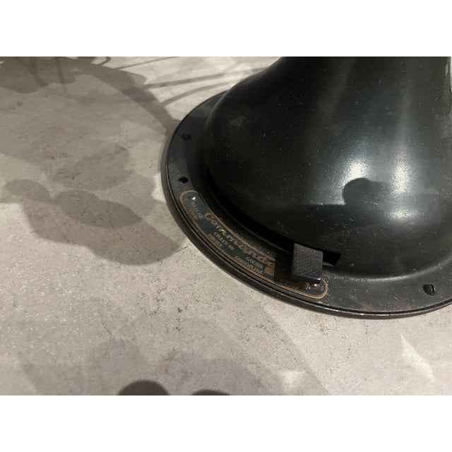 ABOUT An Army green steel and cast iron 6 blade Commandair oscillating fan with tilting head, three power settings,...