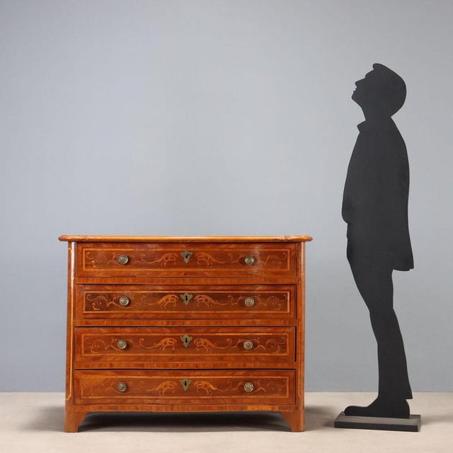 A Piedmontese Baroque walnut chest of drawers dating back to the mid-18th century, featuring exquisite inlaid workmanship....