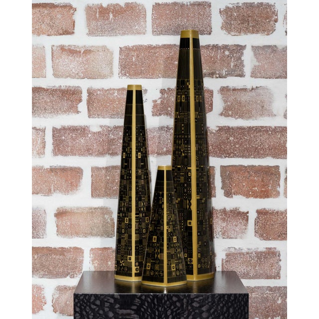 Set of three Rosenthal porcelain vases designed by Hans Theo Baumann in 1964. Model 1703 combines tall, tapering forms...