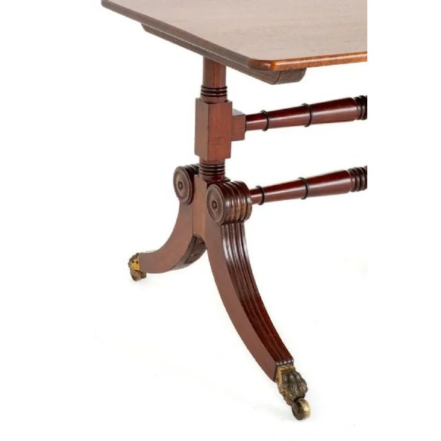 Regency Revival Mahogany Coffee Table Table. This Table Stands upon Shaped and Fluted Swept Legs with Brass Claw Castors....
