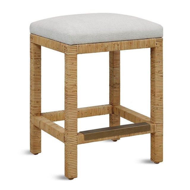 Casual coastal styling meets refined comfort in this counter stool, featuring a natural rattan-wrapped frame and an off-...