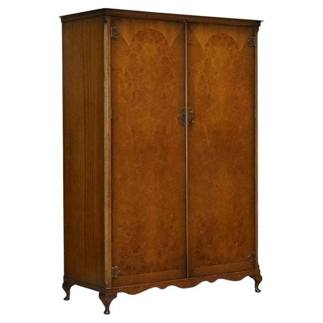 A beautiful Art Deco style English walnut double door wardrobe, made by Dillon, England, featuring elegant proportions,...