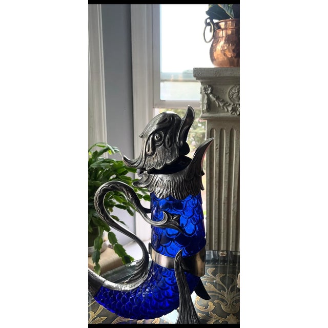 A masterpiece of late-Victorian design, this sterling silver and sapphire-blue glass claret jug captures the union of...