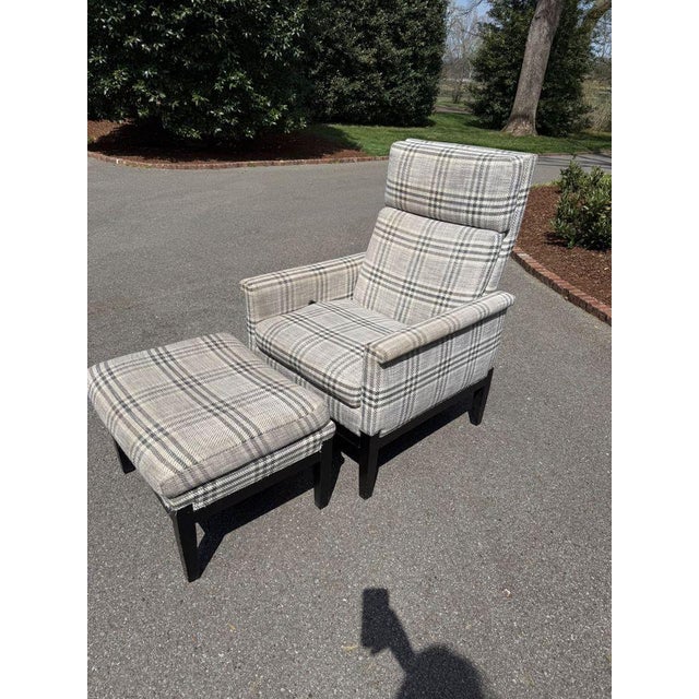 Comfortable reclining armchair by The Hickory Chair Furniture Company. Upholstered in a grey plaid fabric and featuring a...