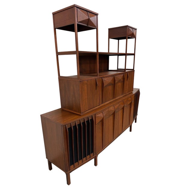 Elevate your interior with this rare circa 1960s Mid-Century Modern Brazilian-style two-piece walnut storage, bar, and...