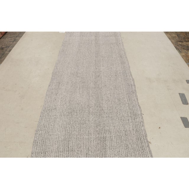 Originating from Turkey in 1980, this vintage wool kilim rug is flat woven in high-quality wool with a contemporary,...