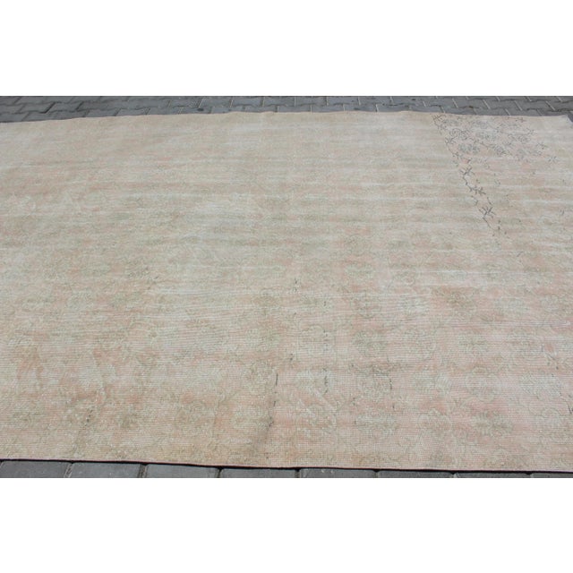 This beautiful, traditional vintage, hand knotted Turkish area rug is approximately 60 years old. It is handmade of very...