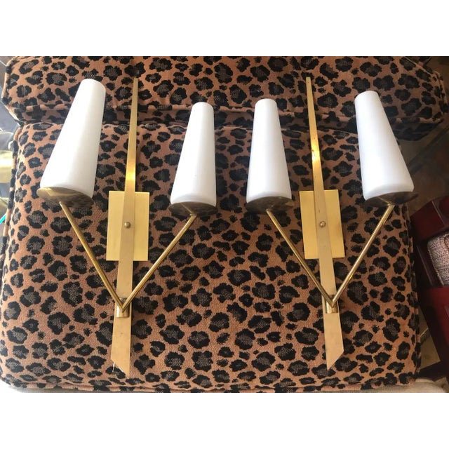 Pair of Mid Century Stilnovo sconces, circa 1950. Minimalist brass with white glass shades. Classic timeless style....