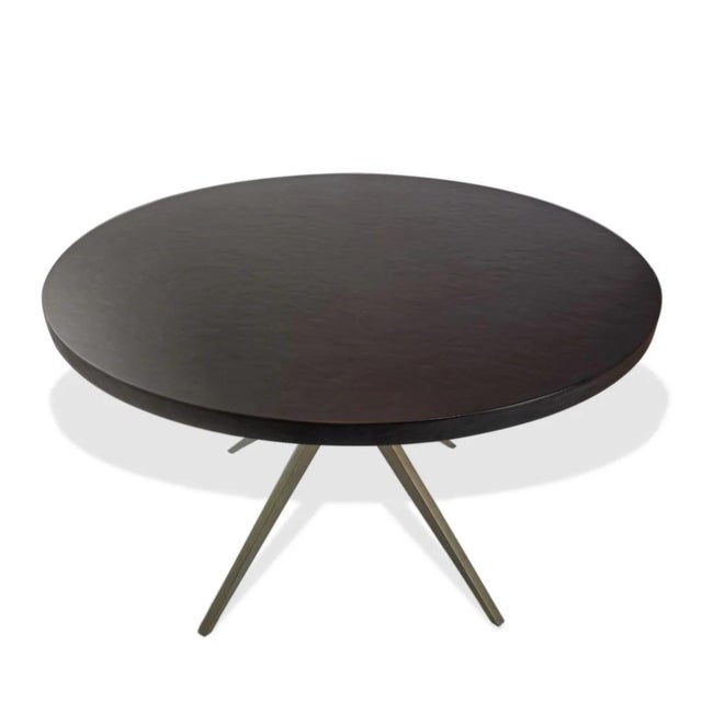 The Atlantis Dining Table from Mr Brown London is a striking contemporary statement piece that blends sculptural form with...