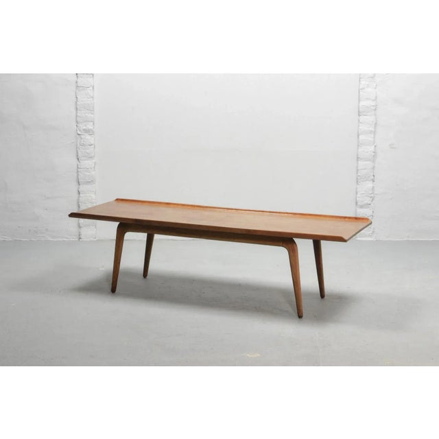 This original solid coffee table in teak with 'boomerang' legs was designed by the Danish designer Aksel Bender Madsen and...