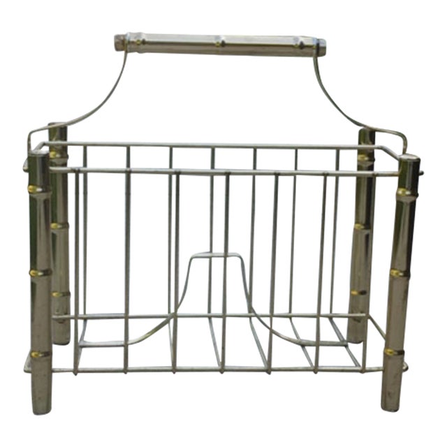 Solidly made brass magazine rack from midcentury. Added details are chrome rings (one shown in photo) and bamboo shaped...