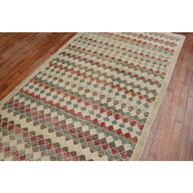 Vintage Turkish Deco rug with an all-over diamond motif on a beige field. Accents in red, brown, green blue and rust....