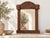A mirror that acts as a talisman. This striking wall mirror is framed by a heavy, architectural surround inspired by the...