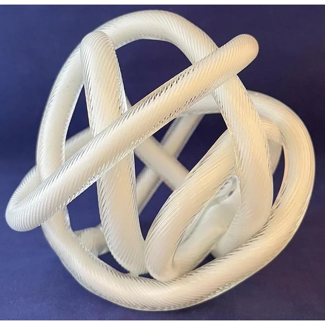 This gorgeous ribbed, twisted-cane glass sculptural knot appears to be 1970–80s Murano glass by maker Licio Zanetti. Hand-...
