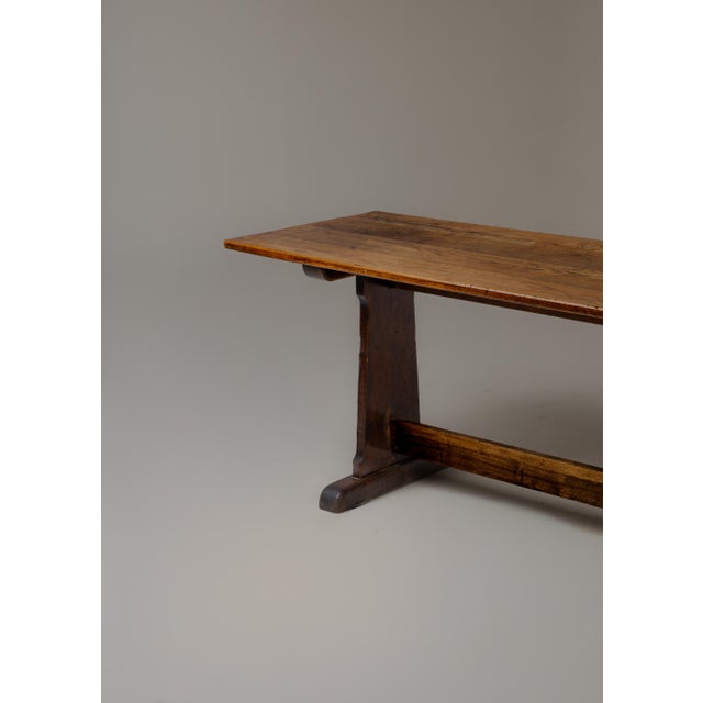 A rare monastery-proportion trestle table from Northern Europe, 8 feet long and 25.75 inches wide. The solid-panel trestle...