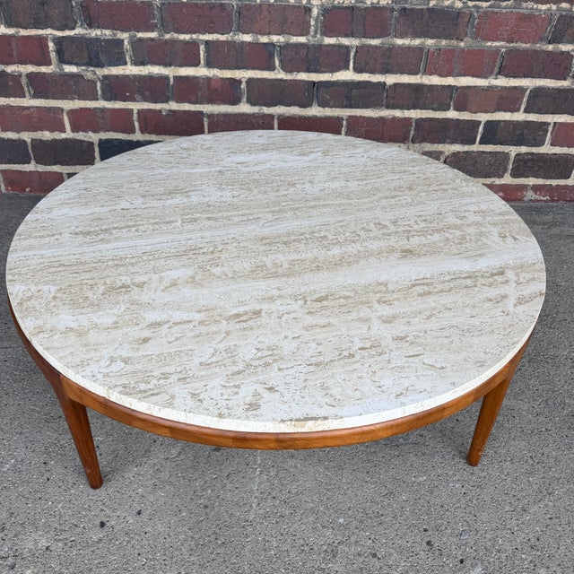 This lovely coffee table by Lane has a solid wood circular base with 4 legs and a cross-supported circular frame. The...