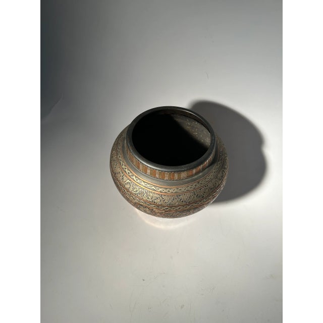 Antique Moroccan mixed metal vase, having copper silver and ebonized metal floral designs.