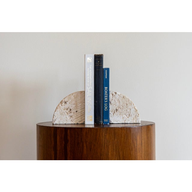 A striking pair of sculptural fossilized coral limestone bookends/blocks. Each piece reveals a distinct character: one cut...