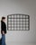 This early 20th century window from France is finished in black, worked in wrought iron. Its form follows honest, well-...