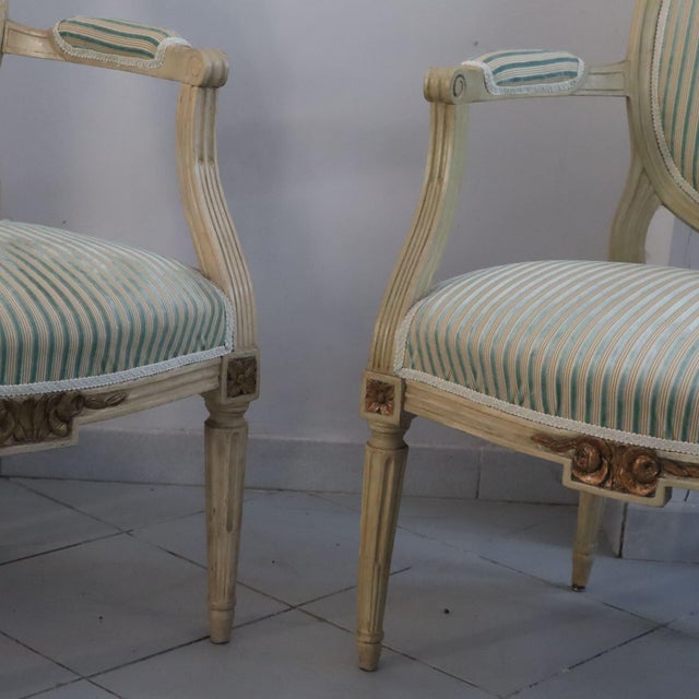 This fine pair of louis xvi style armchairs dates back to the early 1800s and is a perfect example of period french...