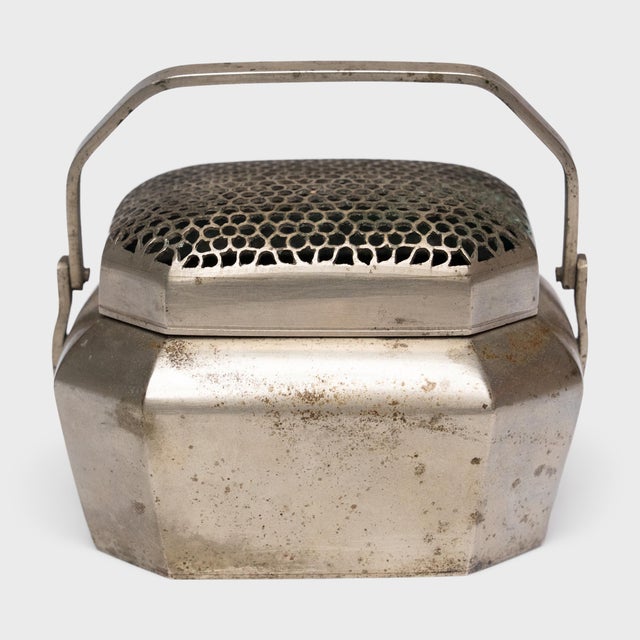 Filled with burning coals, this petite 19th-century brass brazier once warmed the hands of a well-to-do person on a cold...