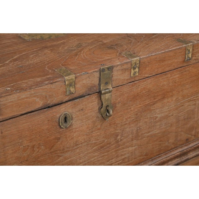 Antique Anglo/IndianTeakwood Blanket Chest/Small Coffee Table, with an ogee shaped bracket plinth with a carved center. In...