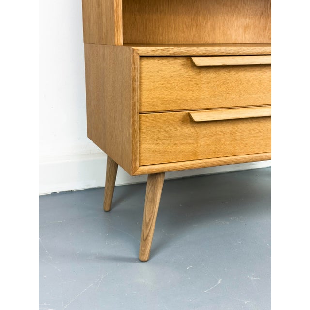 High-quality cabinet in a minimalist, Scandinavian design. The lower section features a drawer unit, while the upper...