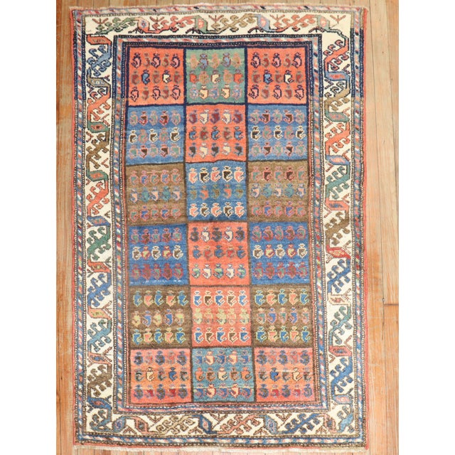 A circa 1940 traditional colorful Persian Bakhtiari scatter size rug with a garden box design Measures: 3'3" x 4'10".