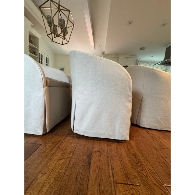 Upholstered in a sturdy pale cream/taupey beige linen with waterfall skirts. The chairs have a chic relaxed linen look....