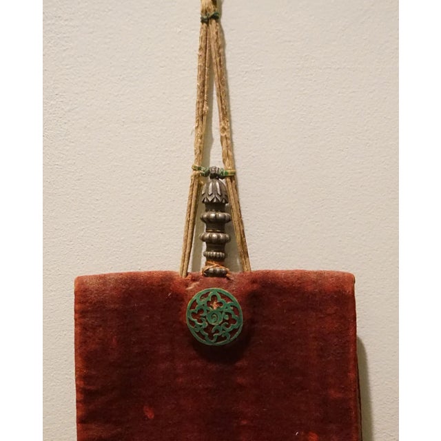 This small elaborate Buddhist monk's medicine bottle is sewn into a larger pouch of rasberry homespun wool fabric with...