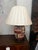 Each lamp features a hand-painted porcelain body adorned with "Six Ladies" and floral motifs in a vibrant Famille Rose...