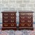 A pair of vintage Chippendale solid mahogany nightstands, each having four drawers with brass bail pulls and decorative...