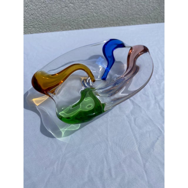 This vintage art glass decorative bowl by Murano is a really stunning find. The organic shape of the bowl with the various...