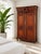 A striking French Provincial Louis XV-style armoire crafted in solid wood with elaborate carved detailing throughout. The...