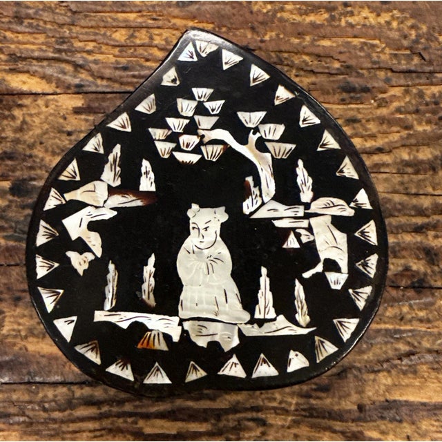 An antique chinoiserie abalone-wood lacquer box with inlaid mother-of-pearl.