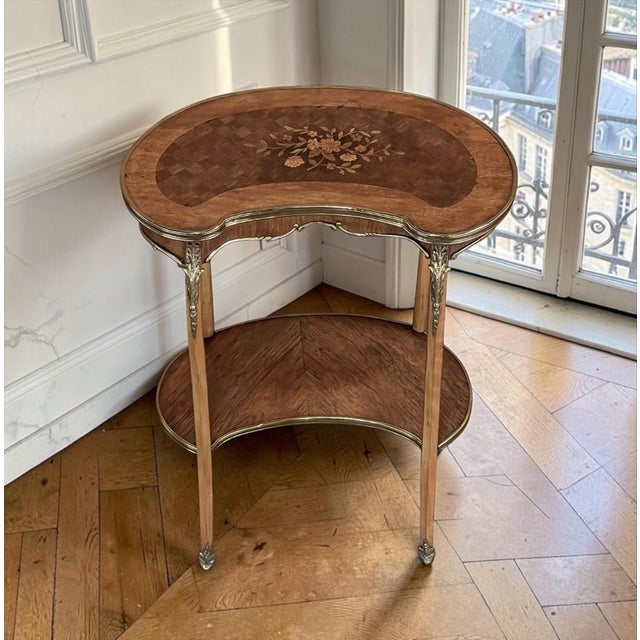 Antique French Louis XV style kidney-shaped accent table, conceived as both a functional surface and an ornament for a...