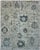 Large slate blue floral motifs alternate with smaller blossoms and fine taupe vines across this handmade Oushak rug. The...